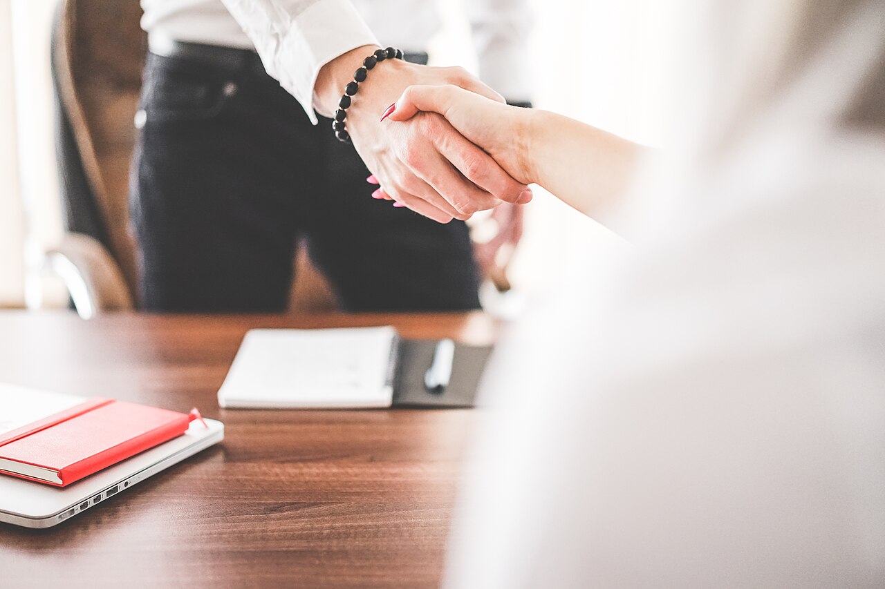 Employer and employee shaking hands after a Bahrain work visa application handled by GovtLink Solutions